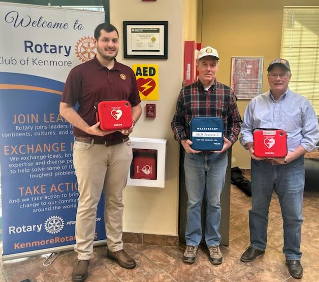 Kenmore Rotary members Brandon Blatz, John (Blue) Hannon and Larry Coon holding recently registered AEDs.